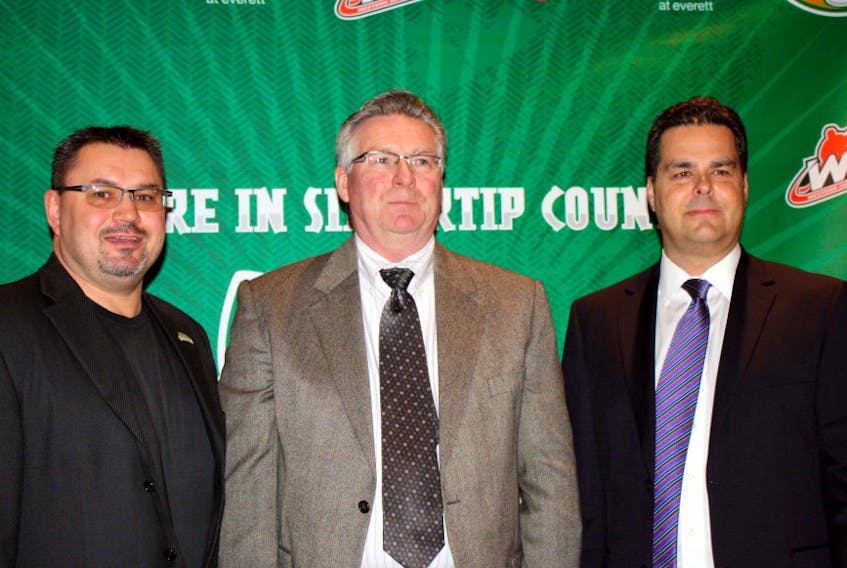Cutline: Gary Gelinas, right, introduces Garry Davidson, centre, as the new general manager of the Everett Silvertips in Everett, Wash., along with assistant general manager Zoran Rajcic, left, on Feb. 15, 2012.