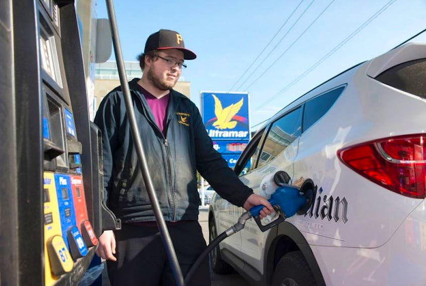 <p>Brandon Bouchard of Cudmore's Ultramar in Charlottetown, fuels up a Guardian vehicle Wednesday. The price of gas has dropped and now ranges from $107.5 cents per litre to $108.6 cents per litre. Diesel, furnace oil and stove oil prices also dropped five cents per litre.</p>