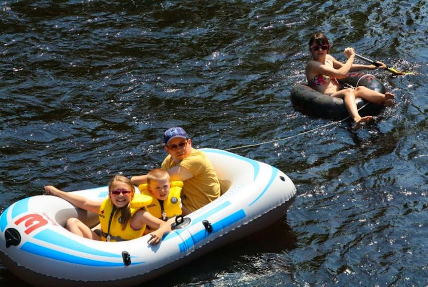 Sandy, Caile, Noah and Alexandria McFadden, Kentville, enjoy one of the summer’s most popular activities – tubing down the Gaspereau River