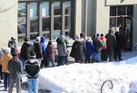 SHOT 16 MARCH 2020
JOE GIBBONS/The Telegram
Guests of The Gathering Place line-up outside the facility over the lunch-hour period on Monday afternoon as they wait in line to go inside for their lunch meal. Due to the COVID-19 breakout, staff at The Gathering Place have had to take extra measures to help combat the safety of staff and guests.  
-Photo by Joe Gibbons/The Telegram

PIC B:
Photo of Joanne Thompson, executive director of The Gathering Place, speaking to Telegram reporter Barb Sweet on the COVID-19 affects to the centre there.
-Photo by Joe Gibbons/The Telegram 

PIC C:
Photo of Audrey Hindy, a guest of The Gathering Place, seen here obtaining her lunch meal from kitchen volunteer Hilda Lambert as staff chef Walter Earle works away in the background.
-Photo by Joe Gibbons/The Telegram 
