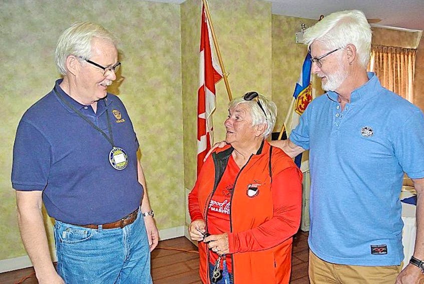 Amherst Rotarian Paul Calder (left) and Sackville, N.B. Rotarian Pam Harrison talk to John Calder about the planned Cliffs of Fundy Geopark