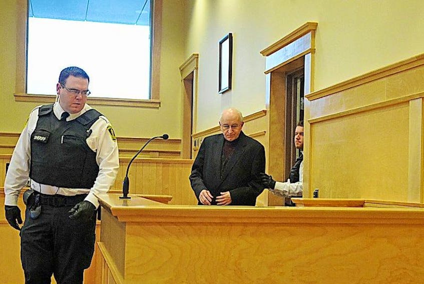 <p>George Ansel Smith enters the courtroom in Corner Brook in this 2013 photo.</p>