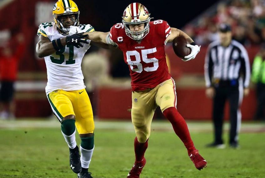 Tight end George Kittle (right) of the 49ers carries the ball after making a catch as strong safety Adrian Amos (left) of the Packers chases during NFL action at Levi's Stadium in Santa Clara, Calif., Nov. 24, 2019.