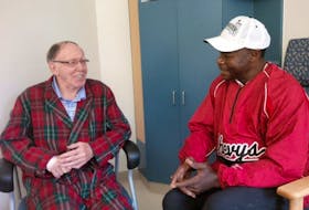 Gerard Dalton, 80, chats with retired baseball star and former Toronto Blue Jay Tony Fernández during a visit at the Prince County Hospital Wednesday. Photo submitted by Adam Binkley&nbsp;