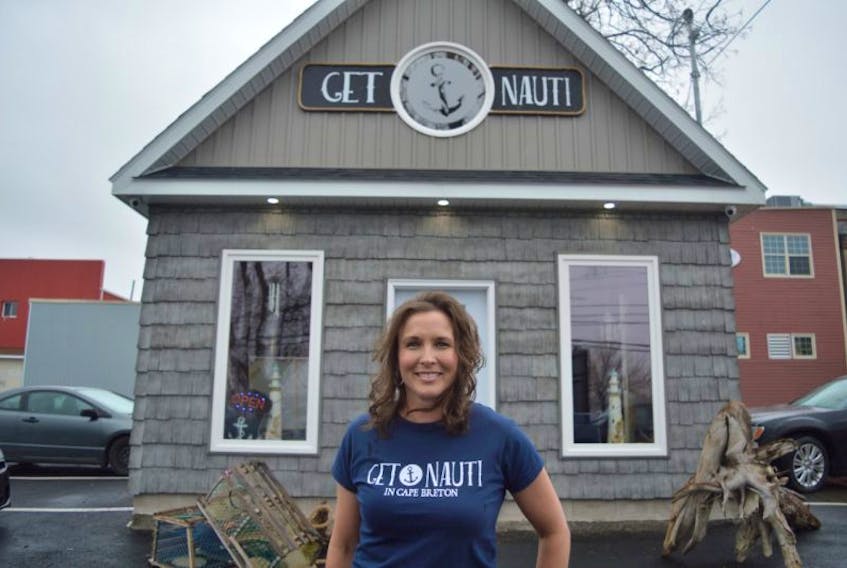 Tonya Blackie owner of Get Nauti gift shop in Sydney stands for a picture in front of her new business on Saturday. The gift shop, which specializes in unique and nautical items, officially opened for business on April 28. 