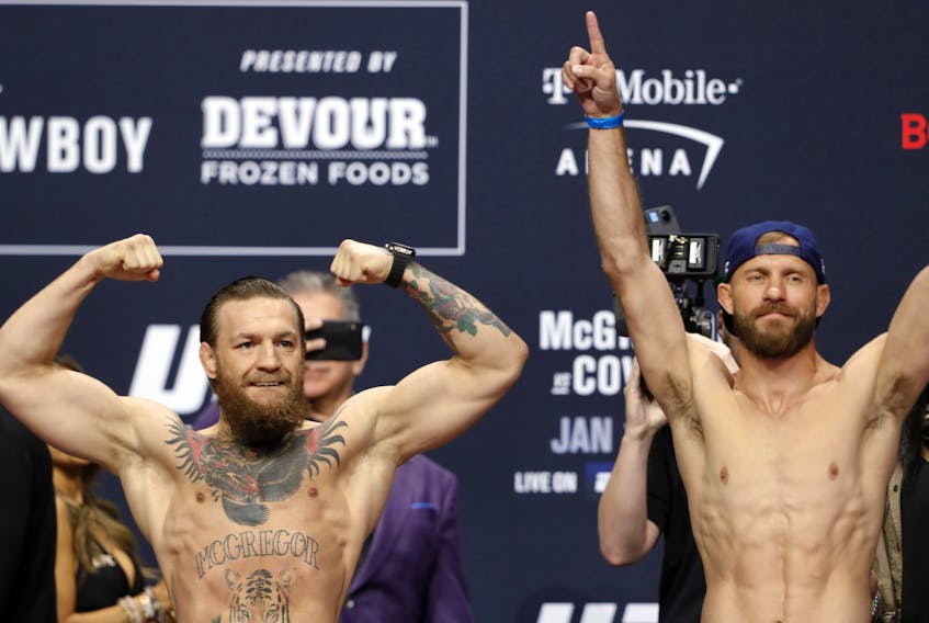 Welterweight fighters Conor McGregor, left, and Donald Cerrone pose during a ceremonial weigh-in for UFC 246 at Park Theater at Park MGM on Jan. 17, 2020 in Las Vegas, Nevada.  (Steve Marcus/Getty Images)