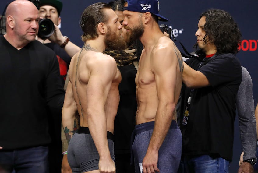 Welterweight fighters Conor McGregor, left, and Donald Cerrone face off during a ceremonial weigh-in for UFC 246 at Park Theater at Park MGM on Jan. 17, 2020 in Las Vegas, Nevada.  (Steve Marcus/Getty Images)