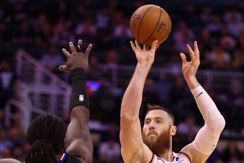 Former Phoenix Sun Aron Baynes attempts a shot over the Clippers’ Montrezl Harrell. Baynes will sign a two-year deal with the Raptors worth 14.3 million. 