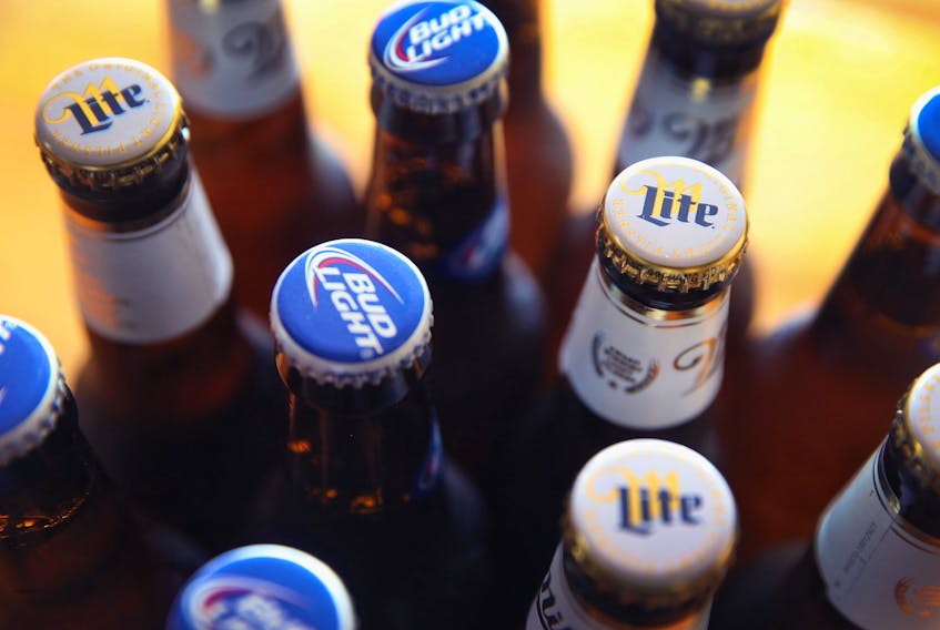 In this photo illustration, bottles of Miller Lite and Bud Light beer that are products of SABMiller and Anheuser-Busch InBev (respectively) are shown on Sept. 15, 2014 in Chicago. Illinois. 