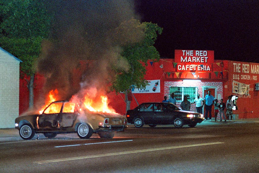 A car buns on NW 54 street in Liberty City area of Miami during Super Bowl Week in 1989. Violence and looting went for days following the shooting of a robbery suspect. The 49ers beat the Bengals in a memorable game.  Getty Images