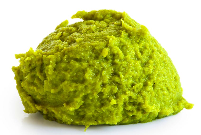Scoop of wasabi paste isolated on white.