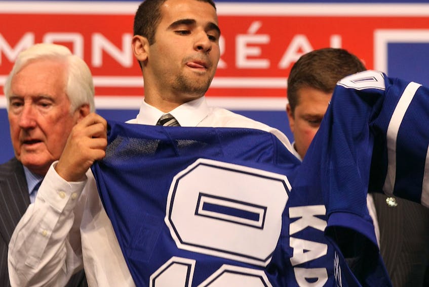 Nazem Kadri puts on his new Toronto Maple Leafs sweater after he was selected #7 overall by the Leafs during the first round of the 2009 NHL Entry Draft at the Bell Centre on June 26, 2009 in Montreal, Quebec, Canada.  (Photo by Bruce Bennett/Getty Images)