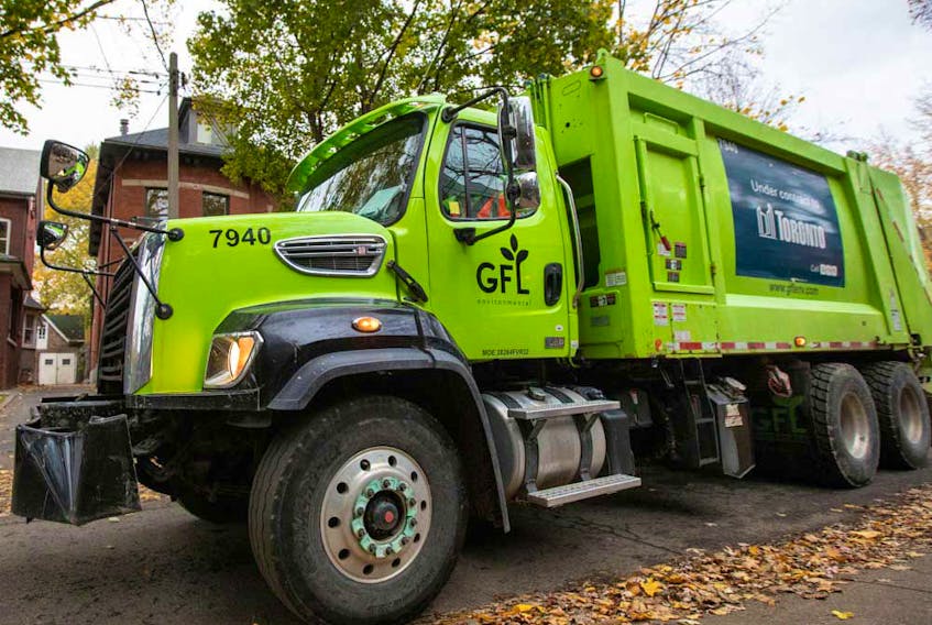 A truck from Canadian waste management company GFL Environmental Inc makes its rounds through a neighbourhood in Toronto. 