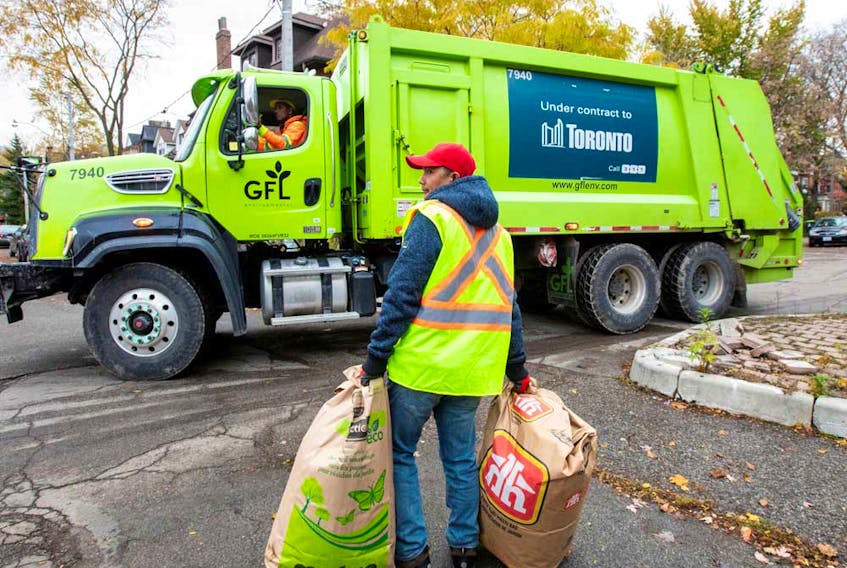 A truck from Canadian waste management company GFL Environmental Inc makes its rounds through a neighbourhood in Toronto.