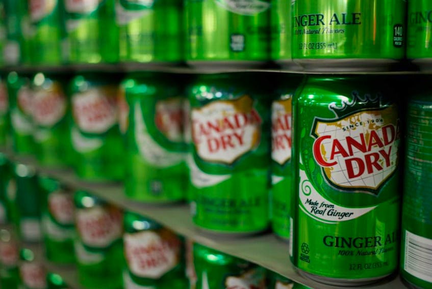 Empty cans of Canada Dry Ginger Ale sit stacked in a warehouse before being filled at the Dr. Pepper Snapple Group Inc. bottling plant in Louisville, Kentucky, U.S., on Tuesday, April 21, 2015. PHOTO BY LUKE SHARRETT/BLOOMBERG.