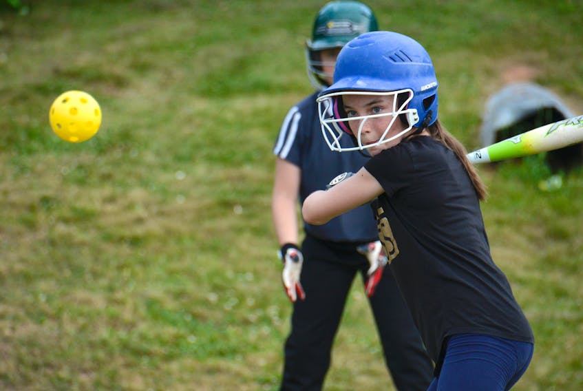 Faith Turner keeps her eye on the wiffle ball during West Royal under-12 girls' softball practice Monday in Charlottetown.