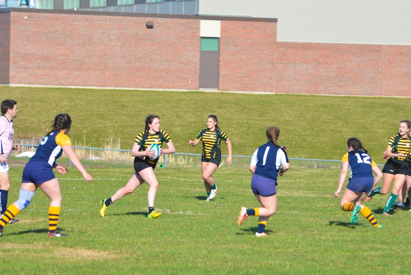 Jordyn Connell of the Three Oaks Axewomen carries the ball up the field during a recent P.E.I. School Athletic Association Senior AAA Girls Rugby League game against the Westisle Wolverines in Summerside.
