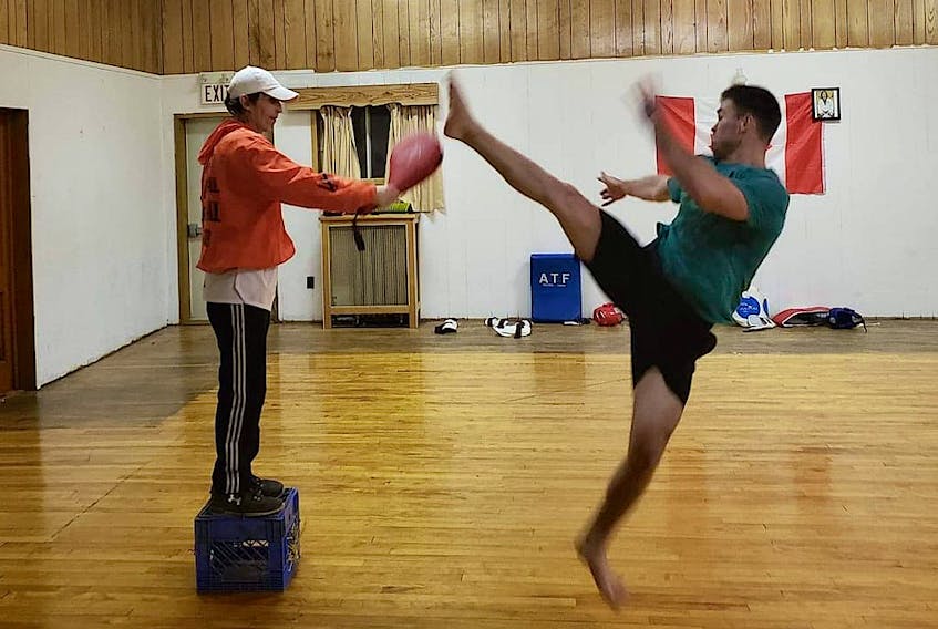 Ashley Taekwondo student Kevin Boutilier, right, fires a kick at the pad instructor Craig Seymour holds during a class in fall 2019. The martial arts school was located in the building on the corner of Commercial and Catherine streets which was destroyed by fire on Jan. 18, 2020, however, thanks to community support, Seymour's reopening in a new location on three days after the blaze. CONTRIBUTED PHOTO