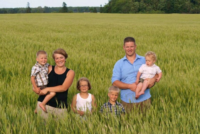 <p>Sally Bernard, shown holding her son, Thayne, along with her children Lucy and Wilson, husband Mark holding Solomon, says introducing GM alfalfa in P.E.I. will open a “Pandora’s box” of problems for organic agriculture.&nbsp;</p>
<p>&nbsp;</p>