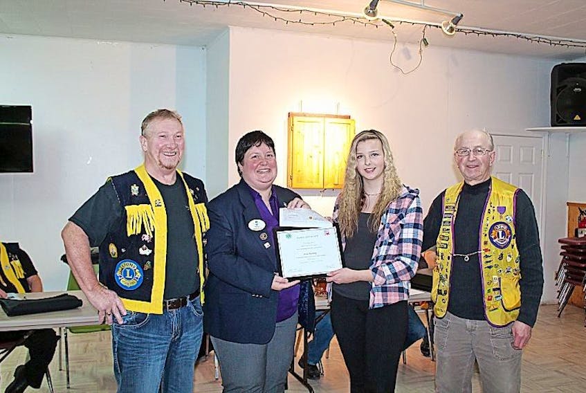 Burgeo resident Sarah Standing was name the first place winner in the Lions Peace Poster contest. Standing was presented with a certificate and a cheque for $200 for her win at the district level. This is three consecutive years that the Burgeo Lions Club have won the Peace Poster Contest. Three years ago they were the first place winner in the Multiple District level. Pictured from left, Lion Max Pink, DG Penny Pike, Sarah Standing and Lion Fred Simms.    