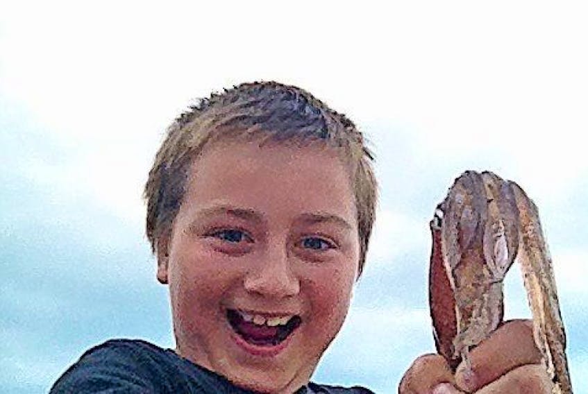 Congratulation’s to Gabriel Kendall for submitting this photo of himself and a squid he caught in Port aux Basques.