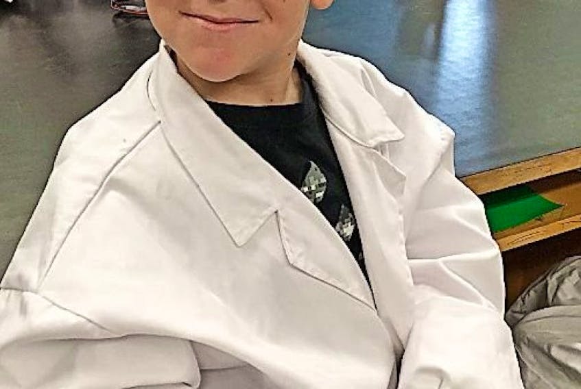 Lance Downey, a Grade 1 student at Belanger Memorial, was suited up and ready to learn during Education Week and a trip to the high school science lab.