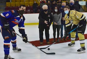 The official puck drop to open the 2020-21 St. John’s Junior Hockey League season took place Friday night at Jack Byrne Arena prior to a game between the Mount Pearl Blades and Northeast Eagles. Gerry Taylor, a Hockey Newfoundland and Labrador Hall of Famer, and one of the league’s founding members, dropped the opening puck. Taylor was assisted by his granddaughter, Melanie Taylor, a gold-medallist for figure skating in the Special Olympics category at the 2019 Canada Winter Games in Red Deer, Alta. From left are Blades captain James O’Brien, Gerry Taylor, Melanie Taylor, Hockey Newfoundland and Labrador president Jack Lee, Eagles captain Patrick Farrell, and junior league vice-president and provincial Junior Council member Jim Hare. — Bob Crocker photo/ St. John’s Junior Hokey League
