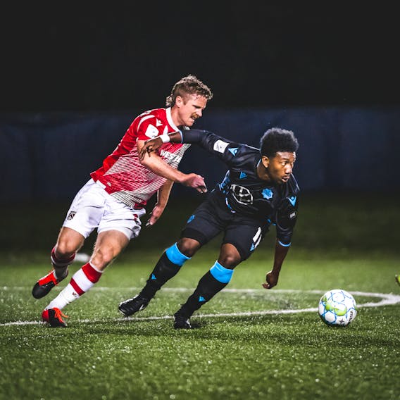 HFX Wanderers striker Akeem Garcia (right) breaks away from a Cavalry FC defender during a 2020 Canadian Premier League match at the Island Games in Charlottetown.  CANADIAN PREMIER LEAGUE
