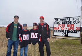 Members of the Glace Bay Miners peewee ‘A’ hockey team stand in front of a sign on Reserve Street in Glace Bay that asks resident to vote for the club in the Chevrolet Good Deeds Cup. The community heard the message loud and clear, helping the team capture the national title on Saturday. From left, Kenzie Wadden (coach), Matthew Jewells, Michael McLean and Nathan MacNeil. 