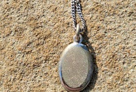 This is the necklace and pendant as photographed by beachcomber Justin Hawley after his metal detector helped him to unearth the treasure that was eventually returned to its rightful owner. Hawley found the memorial keepsake at Port Hood Beach about 10 days after Margie Wiswell lost it while going swimming with her grandsons. The front of the pendant is an image of Wiswell’s late daughter Tammy’s fingerprint, while the back has the word “daughter” and the dates “1981-2019”. CONTRIBUTED