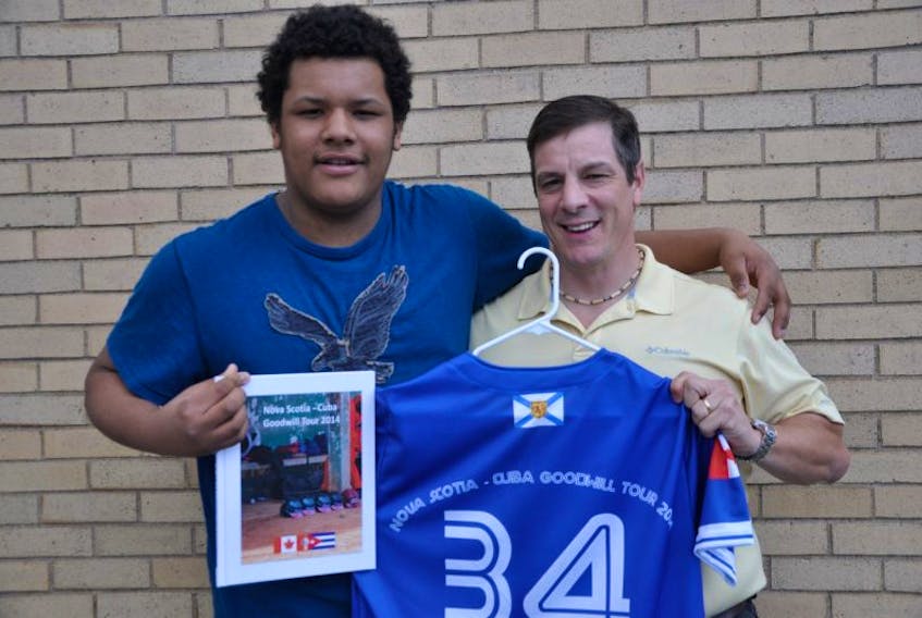 <p>Keeshaun Such, of Hantsport, joined baseball coach Dennis Woodworth for a photo at the launch event for a memory book commemorating the first Nova Scotia–Cuba Goodwill Tour. Woodworth organized the tour, and invited Keeshaun to play on a select team comprised of players from across Nova Scotia.&nbsp;</p>