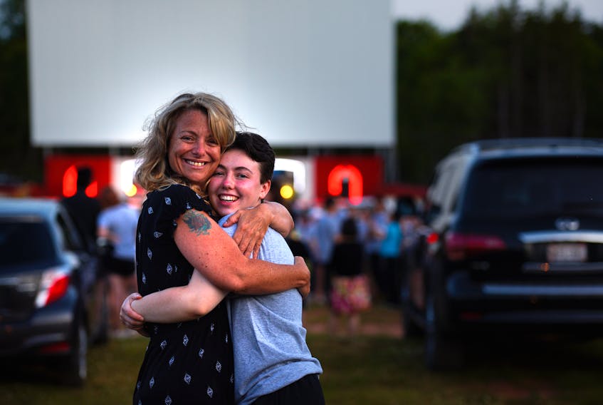 Colonel Gray High School graduate Ken Sillars receives a hug from mom Amy Handrahan at the 2020 graduation ceremony at the Brackley Drive-In on Tuesday.