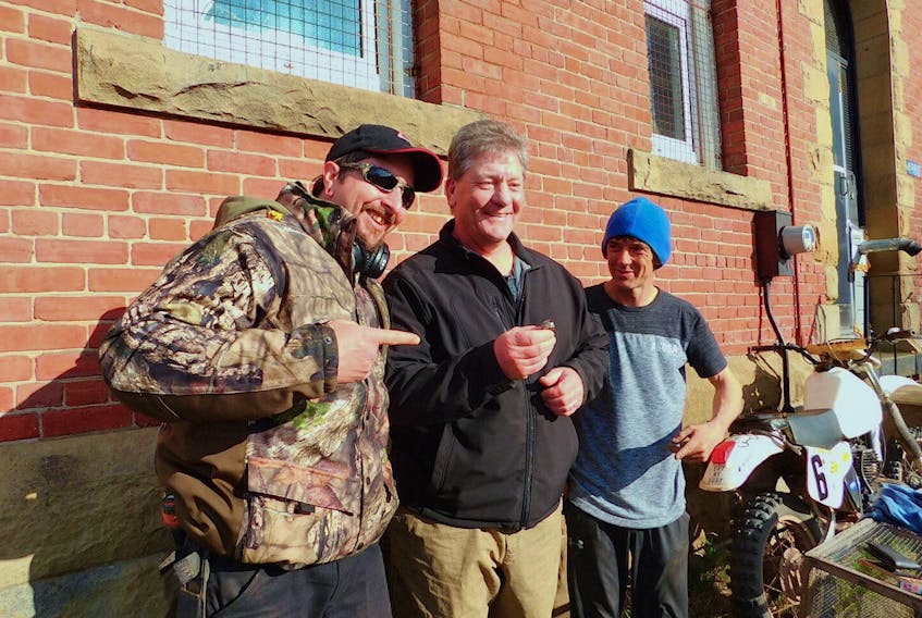 Tantramar Titan alumnus Tim Phinney is excited to have been reunited with his long-lost high school class ring, a treasure discovered on the property of the old Dorchester jail recently by metal detectorists Denis LeBlanc, left, and Tony Jarvis.