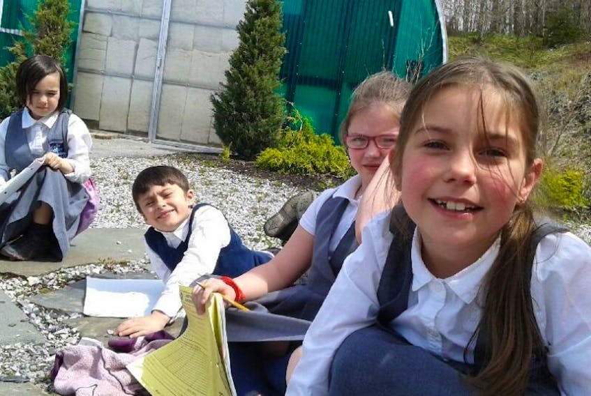 Grade one French Immersion students practice their mind up with a mediation and journal writing session in the school's outdoor classroom earlier this week. Students included (L-R):Katy Hancock, Remy Power, Willow Boland, and Allie Lovell.