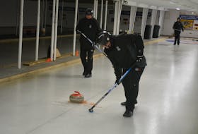 Exploits Hurricanes curlers Gary Wicks, left, and Tony Kryitsis work at sweeping a shot by Margaret MacNeil during practice at the Exploits Curling Club in Grand Falls-Windsor Feb. 18. Nicholas Mercedr/The Central Voice