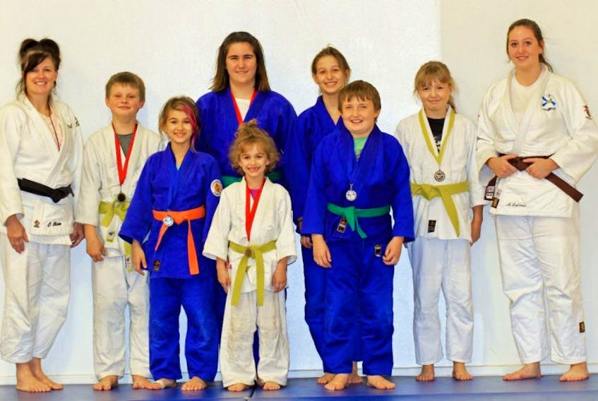 <p>Seven members of the Hachikin Judo Club brought home medals from a recent tournament in New Brunswick. In front is Shona Peddle, who won a gold medal. In back, from left, are sensei Charlene Oliver, Hunter Leblanc (gold), Erika Peddle (silver), Emilie Townsend (gold), Hailey Peddle (silver), Ian Langille (silver), Beth Cook (bronze) and assistant coach Mikalya Latimer.</p>