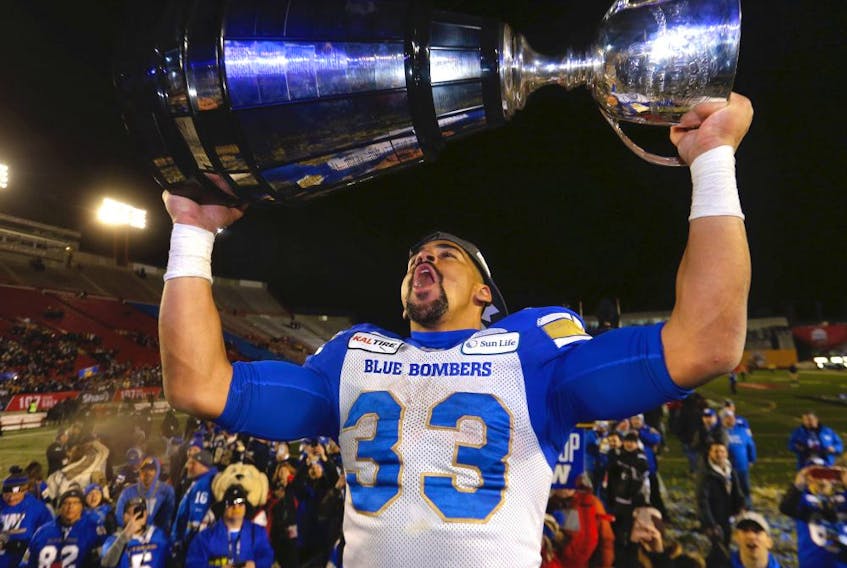 Winnipeg Blue Bombers, Andrew Harris hoists the Grey Cup after beating the  Hamilton Tiger-Cats in the 107th Grey Cup at McMahon stadium in Calgary on Sunday, November 24, 2019. 