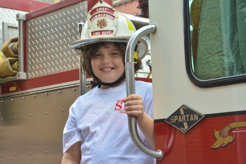 ['<p>Ten-year-old Griffin Read stands on a fire truck at the Summerside Fire Department. Griffin was diagnosed with cancer, and members of the department hosted a special day for him on Friday by picking him up at his house in a fire truck and making him an honorary fire chief.</p>']