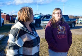 Tracy Tighe looks on as daughter Abby, a Grade 12 student at Breton Education Centre, watches as her 2008 Hyundai Accent is recovered from Lingan Bay. The vehicle, which included some Christmas presents still in the trunk, was stolen from Sydney River on Christmas Eve. DAVID JALA/CAPE BRETON POST 