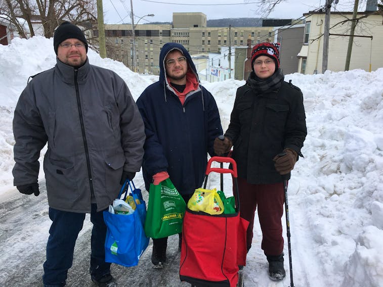 Tony Legge (left), Daniel Sharpe and Ann Norris went to several different stores Tuesday to buy food when the lineups at the Blackmarsh Road Dominion in St. John's were too long when the state of emergency was lifted for people to get groceries and certain essentials. BARB SWEET/THE TELEGRAM
