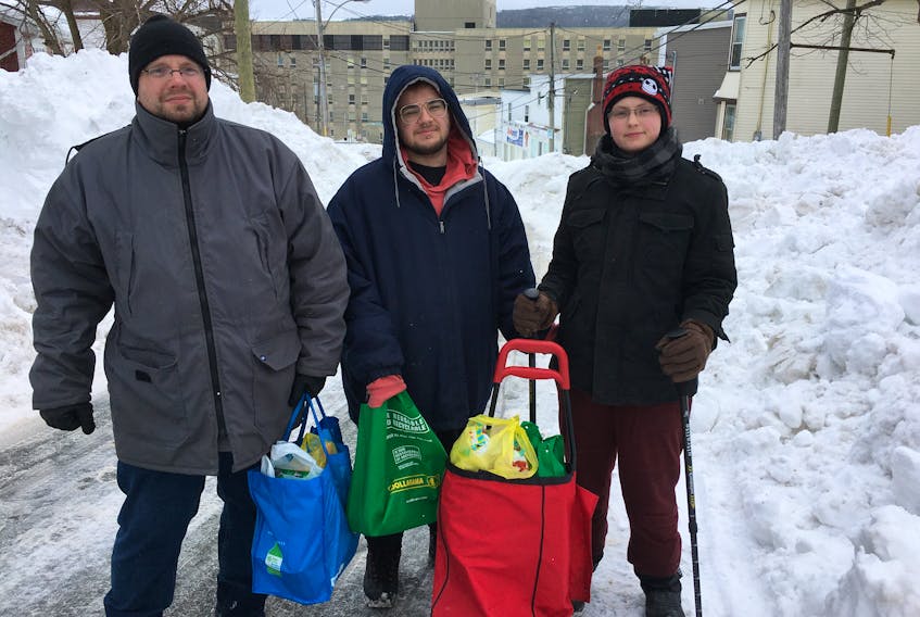 Tony Legge (left), Daniel Sharpe and Ann Norris went to several different stores Tuesday to buy food when the lineups at the Blackmarsh Road Dominion in St. John's were too long when the state of emergency was lifted for people to get groceries and certain essentials. BARB SWEET/THE TELEGRAM
