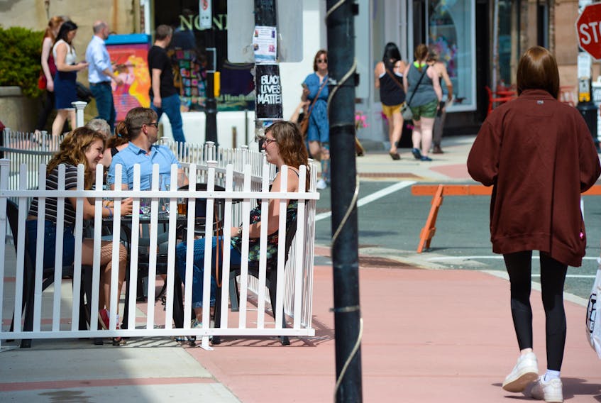 Water Street in St. John’s appeared a little busier Thursday after the province went to Alert Level 2. Diners and pedestrians took advantage of the sun and warm weather to stroll the downtown and eat at some of the restaurants, including ones with outdoor patios. - Keith Gosse/The Telegram