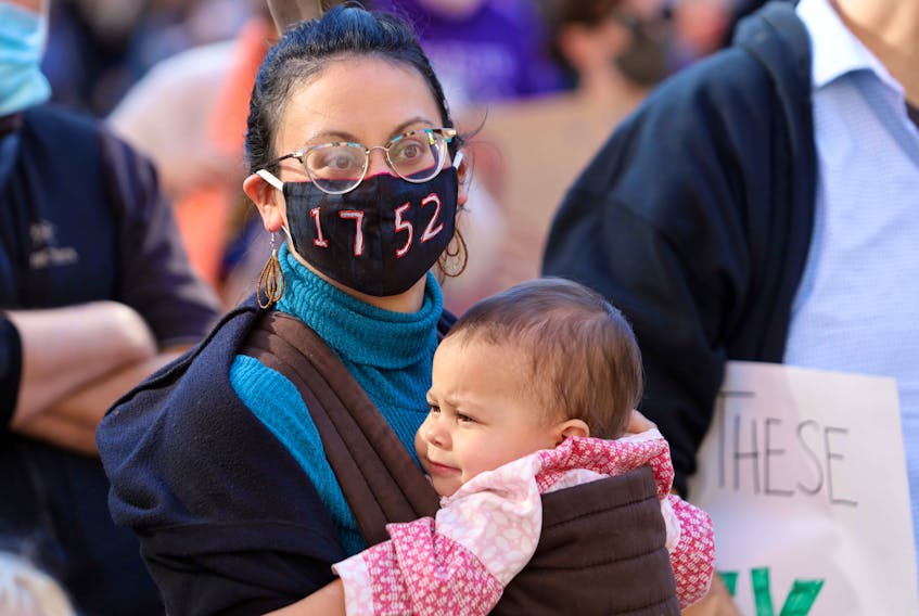 Mi’kmaq Matriach Carmen Bartlett and her daughter Aria, 1, participate in a rally in October in Halifax in support of the Mi’kmaq nation and lobster fishers. Her mask bears the number 1752 in recognition of the Treaty of 1752 between the the governor of Nova Scotia and the Mi'kmaq people guaranteeing certain rights including fishing and hunting.
ERIC WYNNE/SaltWire Network