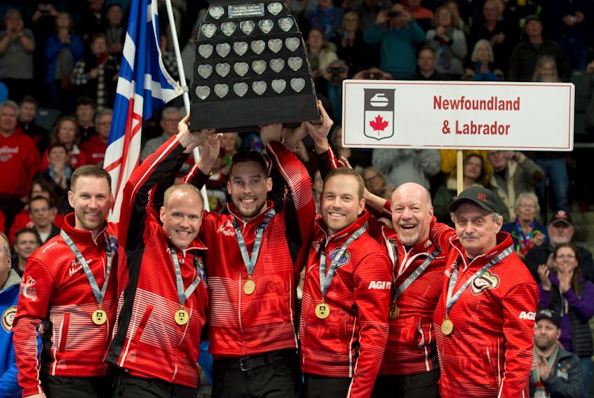 Members of Newfoundland and Labrador’s team (from left), skip Brad Gushue, third Mark Nichols, second Brett Gallant, lead Geoff Walker, spare Jeff Thomas and coach Jules Owchar hoist the Tankard championship trophy after winning the 2020 Tim Hortons Brier in Kingston, Ont., last month. — Curling Canada photo/Michael Burns