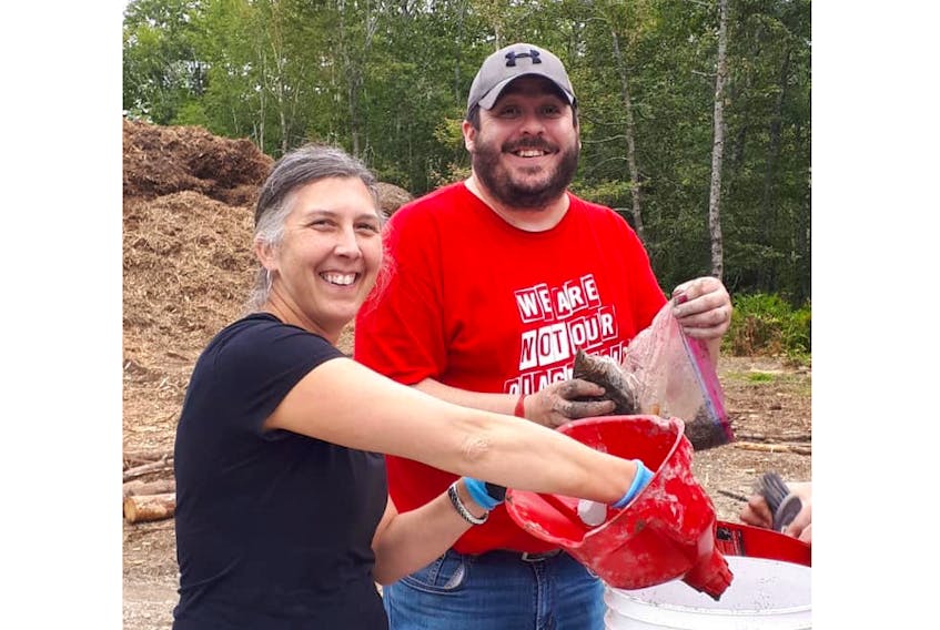 Stacey Harrison, executive director at the Colchester-East Hants Hospice Society, and Mike Francis, program support coordinator, recently spent some time on Oak Island, packing soil samples for a fundraiser. The money will go toward the society and the Health Services Foundation of the South Shore.