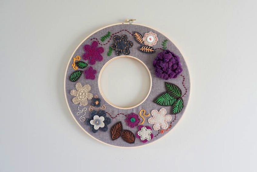 Using hoops, felt, embroidery floss and a few old buttons, Heather hand-stitched a modern fall wreath.