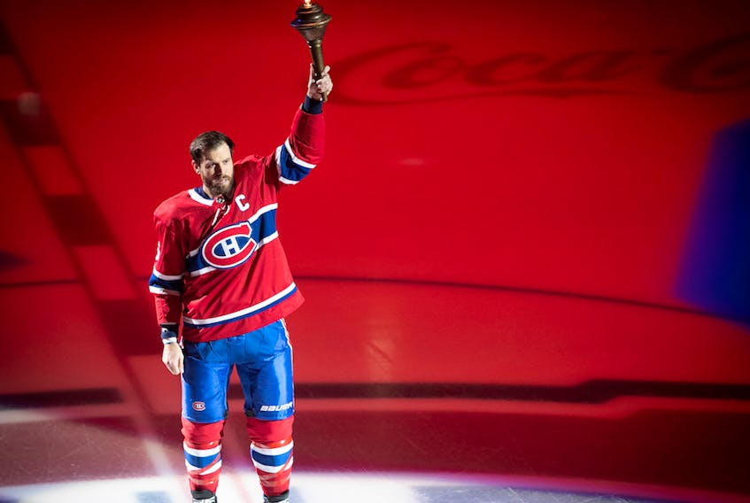 Shea Weber raises torch during opening ceremony at the Bell Centre on Oct. 10, 2019. 