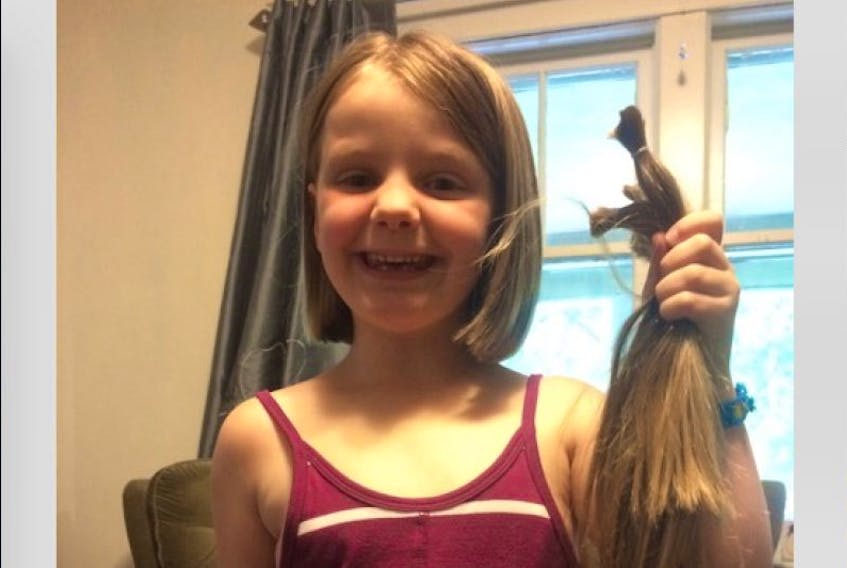 <p>&nbsp;Isabelle Taylor, seven, was proud to cut her hair to help make wigs for cancer patients.</p>