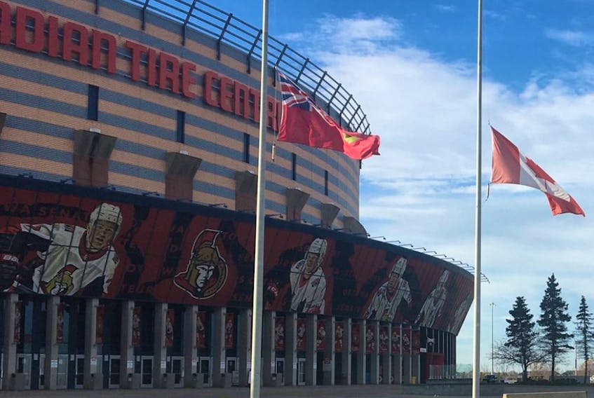 Flags fly at half mast at the Canadian Tire Centre on Nov. 9, 2020 in honour of Alex Trebek who died of pancreatic cancer at the age of 80.