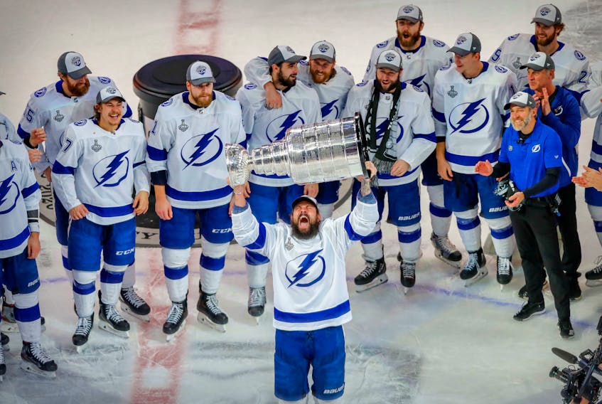 Tampa Bay Lightning defenceman Zach Bogosian (24) hoists the Stanley Cup after defeating the Dallas Stars in Game 6 of the 2020 Stanley Cup final in Edmonton on Monday night. Perry Nelson / USA TODAY Sports